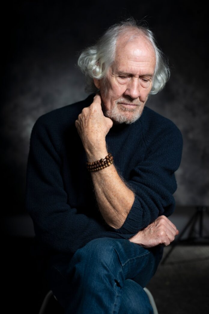 man in black long sleeve shirt sitting on chair
