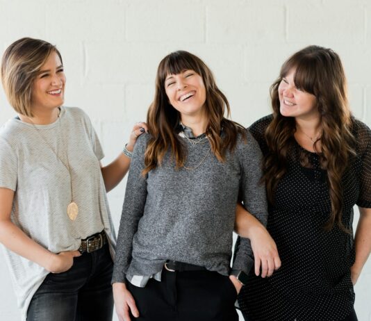 갱년기 증상 완화와 호르몬 건강 지키는 생활습관과 관리법 3 women smiling and standing beside white wall
