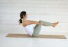필라테스, 현대인 건강 지키는 일상 운동으로 자리잡다 Woman in boat pose on yoga mat