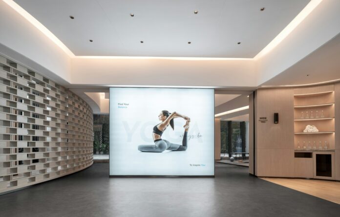 Woman in yoga pose on illuminated display